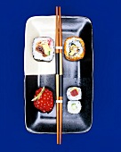 Futo maki, California roll, maki sushi and maki gunkan on plate with chopsticks