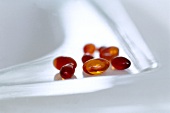 Close-up of vitamin capsules on plate