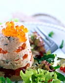 Close-up of timbale of smoked salmon with salad and trout caviar on plate