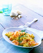 Saffron risotto carrots with smoked salmon in white serving dish