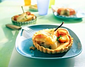 Mini cheese quiche with pear served on plate