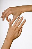Close-up of woman's hands receiving massage on little finger