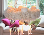 Wreath of white feathers with ball candles and silver hearts