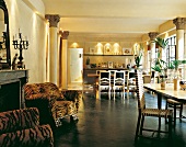 Room with fire place, leopard-skin armchair and dining area