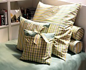 Green and yellow plaid coat pillow on sofa