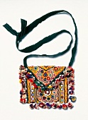 Indian fabric bag in patchwork look with small mirrors on white background