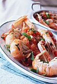 Lobsters with tomatoes, herbs and olive oil on plate