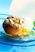 Close-up of halved peach with almond flakes and ice cream on glass plate