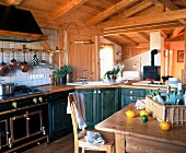 Kitchen with stained pine wood, table, chair, wash basin and drawers