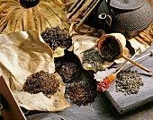 Kandisstabchen, teapot and different types of tea on dried leaves