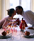 Couple kissing at candle light dinner