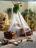 Room with bamboo poles and mosquito net over the bed