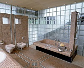 Badewanne mit schwarzem  Acrylglas Sockel,Duschsäule an der Wanne.