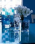 Table of three square glass vases with white flowers