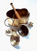 Singing bowl, cymbals and bell against white background
