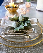 Napkin wrapped with pear fruit ring on gold rim glass plate