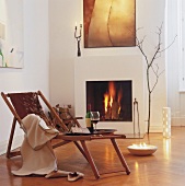 Living room with fireplace and tray of wine on deck chair with pony fur cover