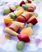 Vegetables, sausage and mixed fruits in skewers