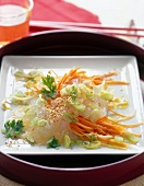Glass noodle salad with sprouts, carrots and spring onion on white square plate