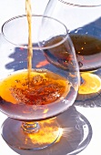 Close-up of brandy being poured into a snifter