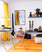 Modern desk and chair with ethnic-art objects on shelf