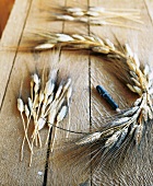 Close-up of craft materials for preparation of corn wreath on wooden table