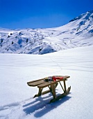 Wooden sled on snow covered landscape
