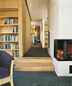 Granite slabs, fireplace and corridor with wooden panels and steps in living room