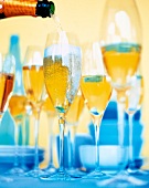 Close-up of glasses being filled with champagne