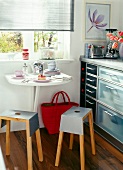 Space saving kitchen with wall folding table and stackable iron stool