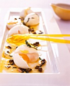 Soft wax eggs in lemon with anchovies on tray