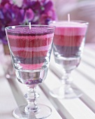 Close-up of layered scented sand candles in glasses