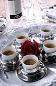 Espresso coffee in silver cups served on silver platter
