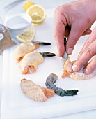 Close-up of man's hands filling boneless wing of scampi