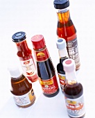 Different Asian sauces on white background