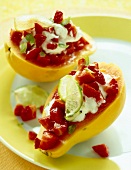 Close-up of papaya with chopped strawberries, lime and curd on plate