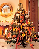 Christmas tree with lit candles, baubles and lantern shaped gingerbread