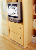 Wooden storage space for television with glass sliding door