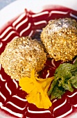 Close-up of chestnut balls with sour cherry sauce