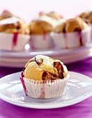 Plum muffin in cake case on plate