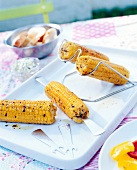 Grilled corn with picker on corn holder