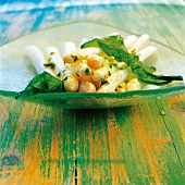 White asparagus with sea lettuce and melted butter in glass bowl kept on wooden table