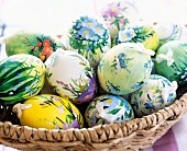 Floral pattern painted duck eggs in a basket