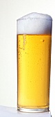 Glass of beer with froth, close-up