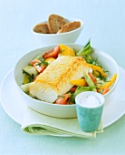 Zander on vegetables in serving dish with rolls a cup of rice