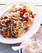 Close-up of thin ribbon pasta with mushroom sauce on white plate