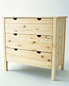 Drawer chest made of untreated wood on white background