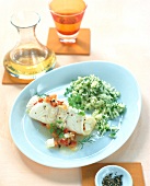 Fish roulade with herb rice on plate