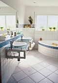 Bathroom with rounded bathtub and white tiles