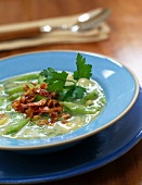 Close-up of green bean soup with bacon on plate